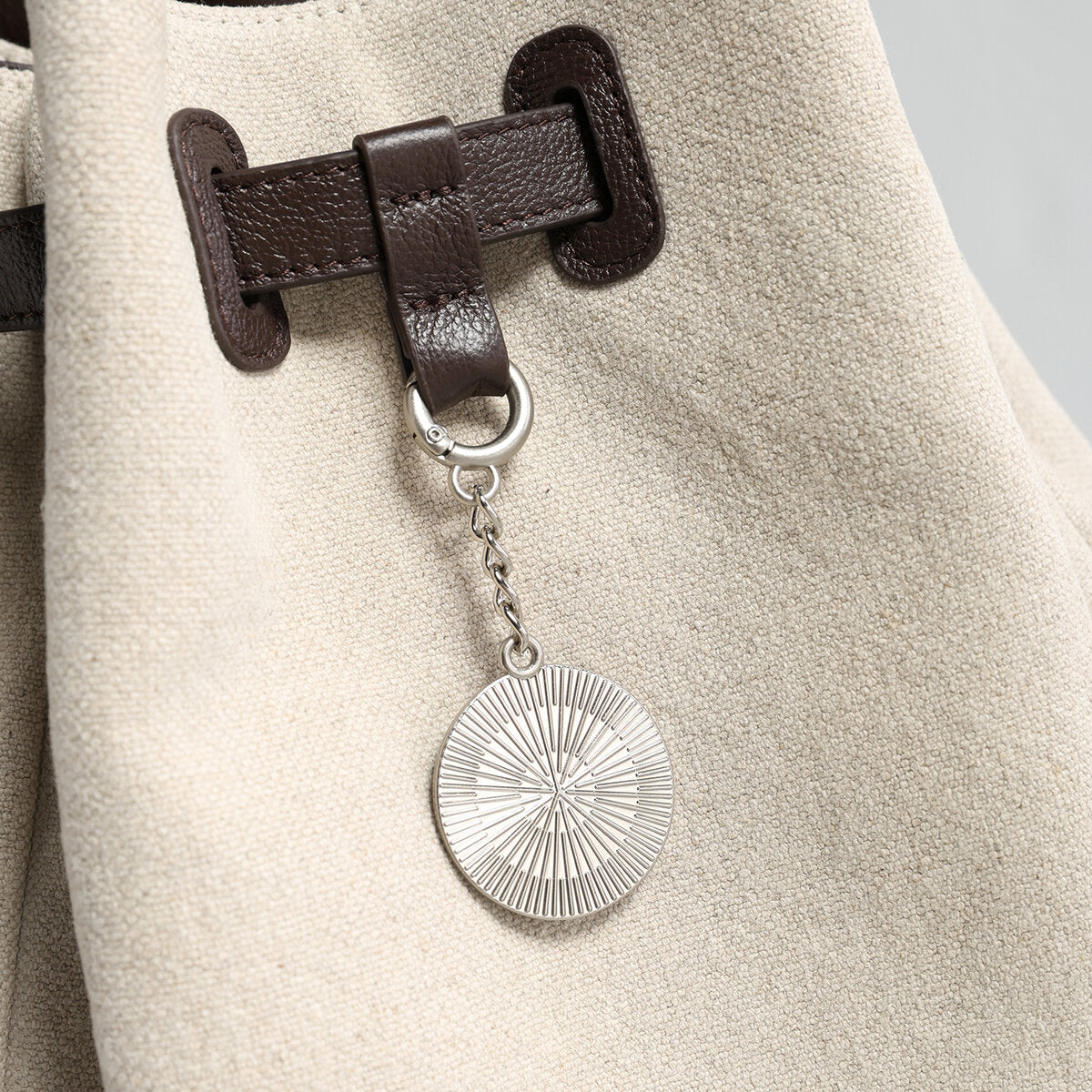 Canvas & Leather Drawstring Bucket Backpack – Convertible Daypack with Sunburst Charm