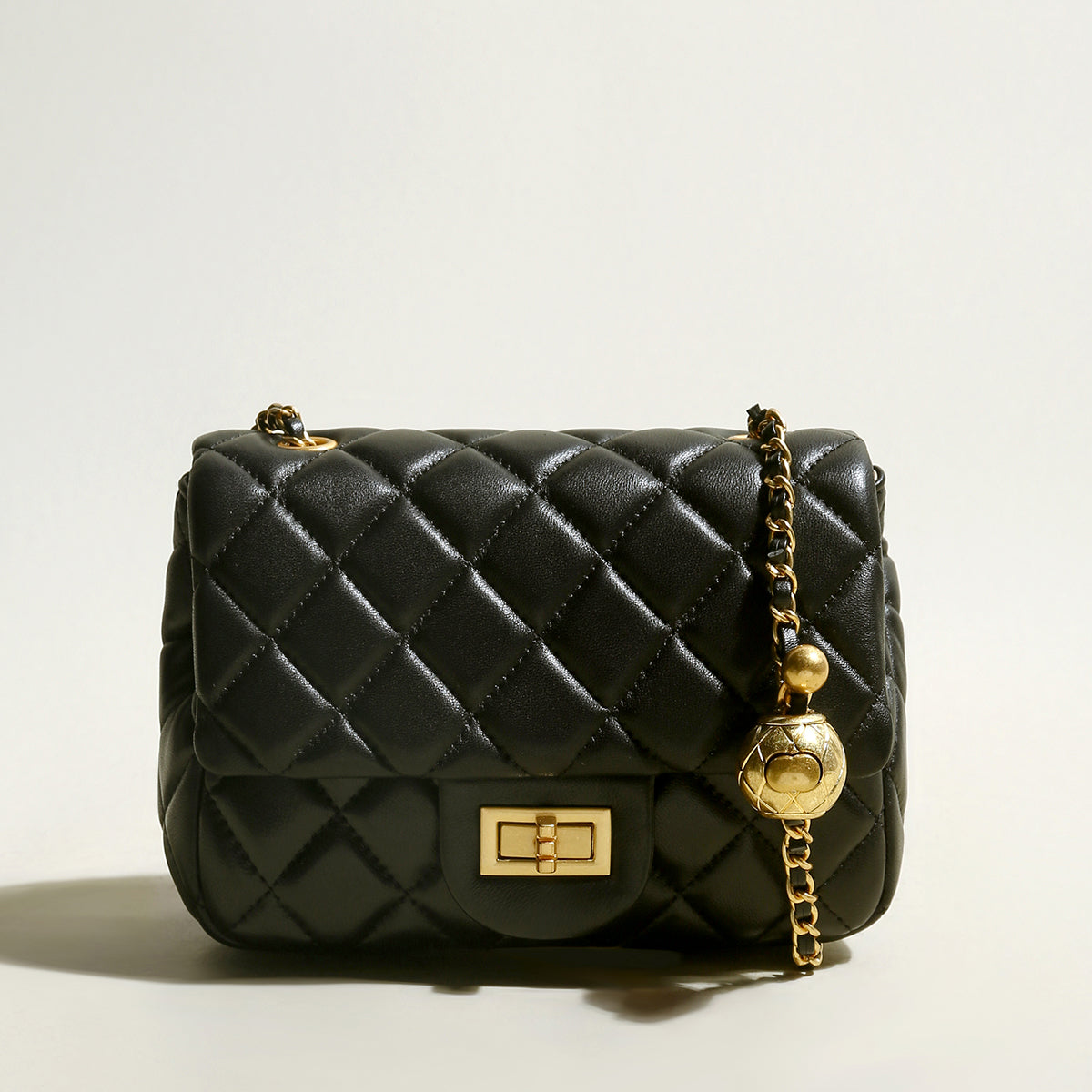 black-quilted-bag-with-golden-ball-leather-chain-straps_black_1.jpg