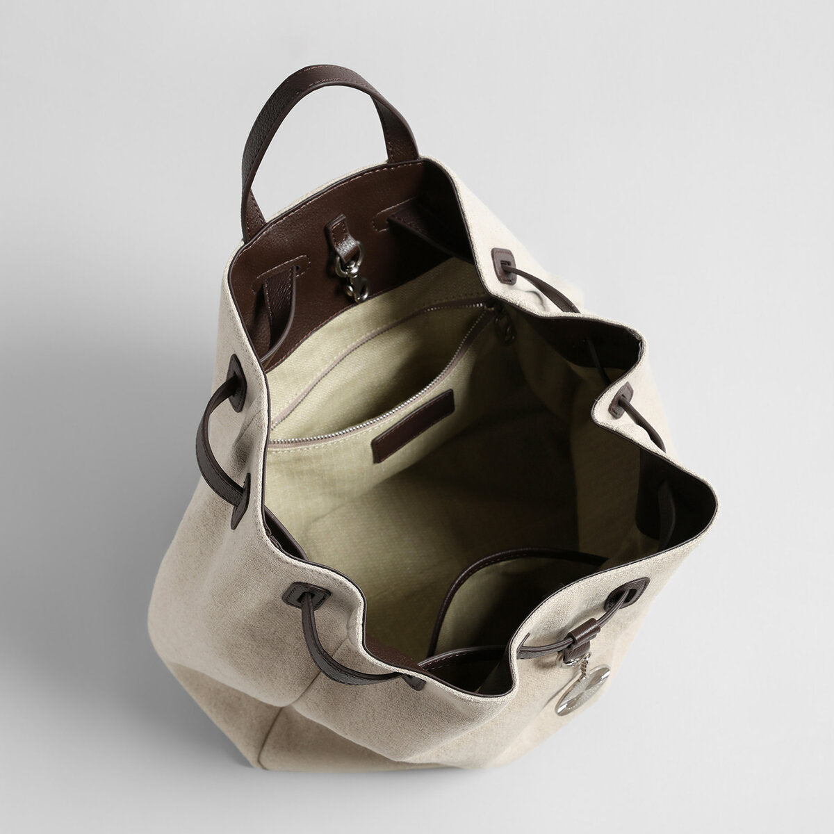 Canvas & Leather Drawstring Bucket Backpack – Convertible Daypack with Sunburst Charm