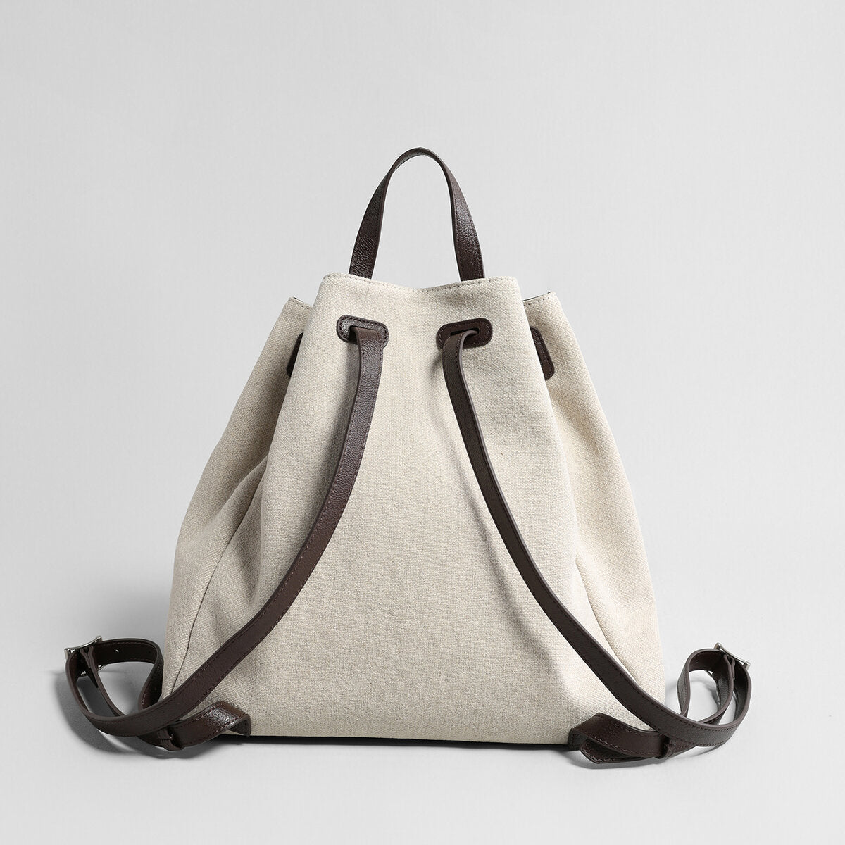 Canvas & Leather Drawstring Bucket Backpack – Convertible Daypack with Sunburst Charm
