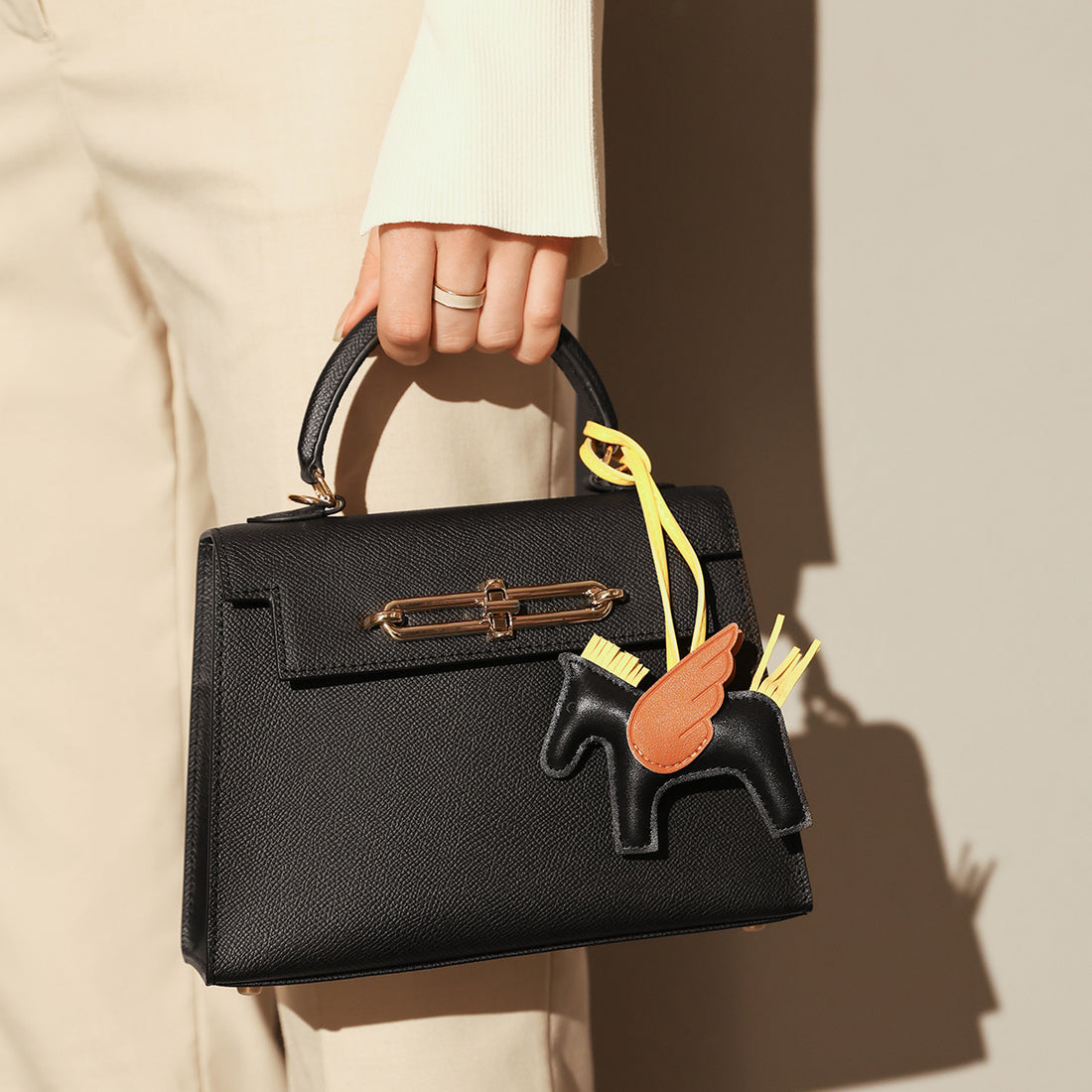 classic-handbag-with-a-unicorn-bag-charm_black_1.jpg