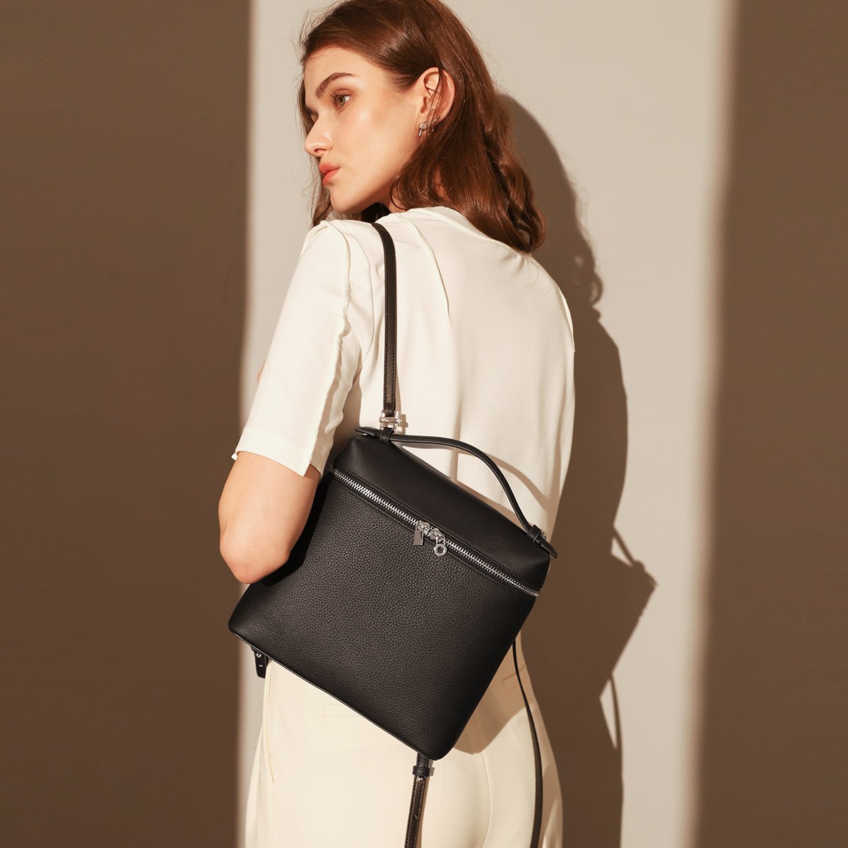 Convertible Pebbled Leather Backpack – Trapezoid Top-Handle Bag with Double Zip & Padlock Detail