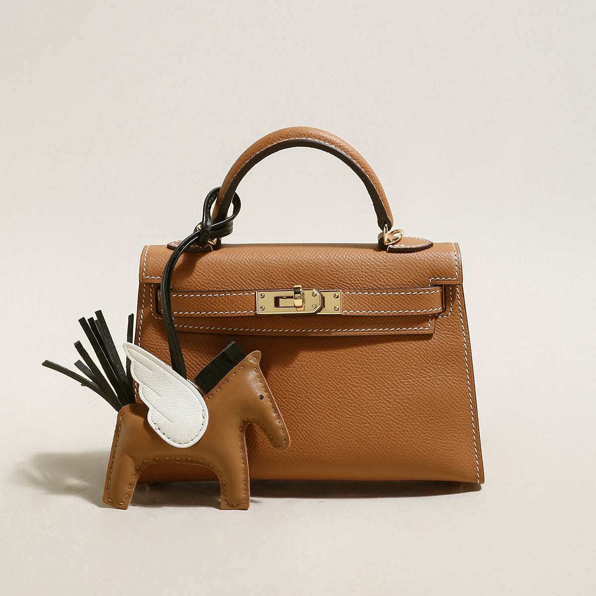 trendy petite top handle bag with a horse charm brown 1